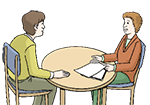 Eine Frau und ein Mann sitzen am Tisch und sprechen miteinander